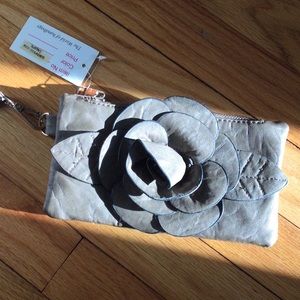 Small clutch purse.  Taupe with decoration.